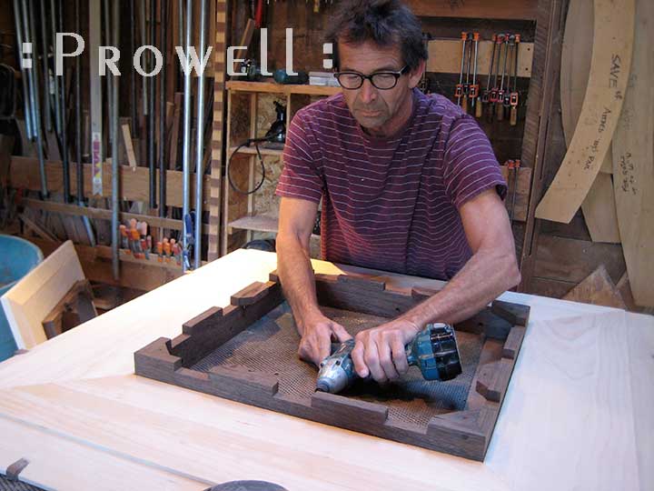 Photograph showing charles building an oversize wood post cap