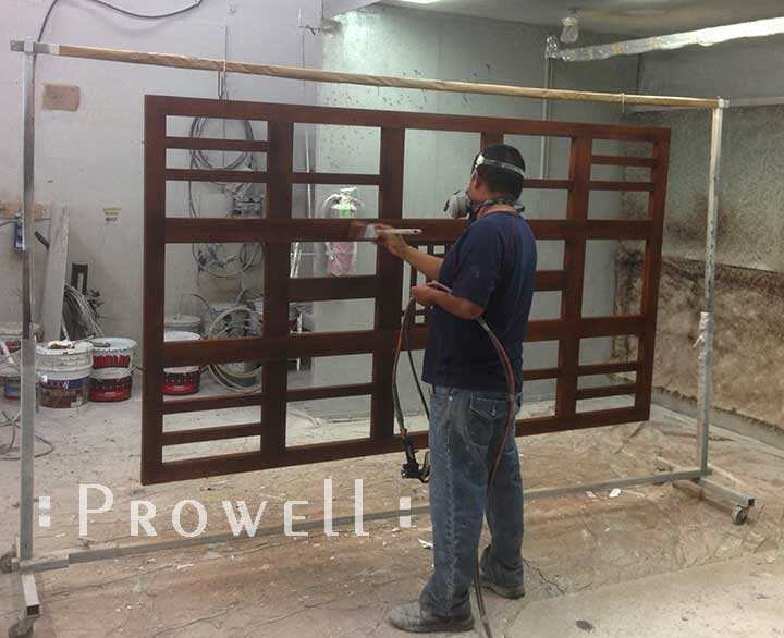 spraying WoodRX on a wood trellis