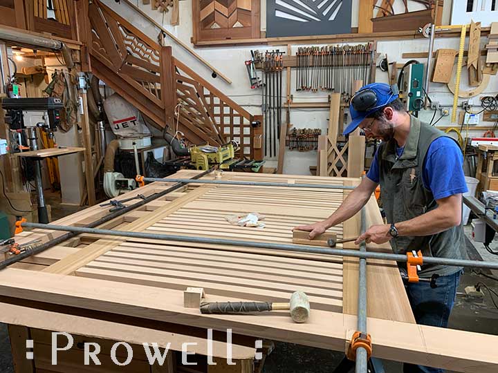 shop progress photograph showing ben prowell aligning the horizontal driveway gates #11-1pickets for the