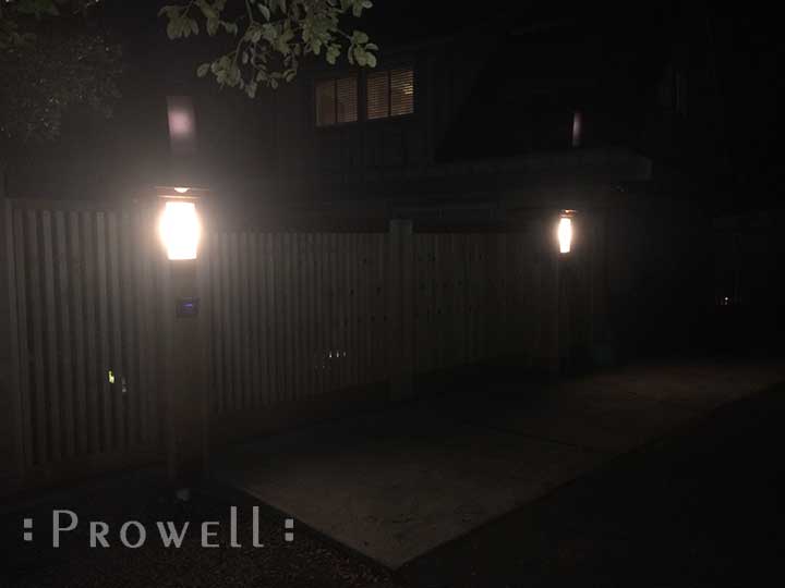 night photograph showing the lighted columns for the sliding wood gate #4