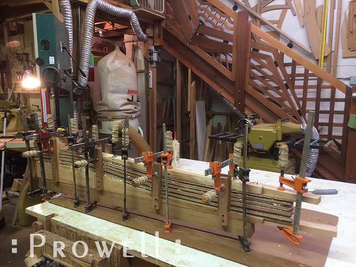shop progress photo showing the process for laminating curves in with an abstract gate design