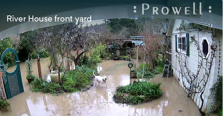 Photograph of the flooded residence with wooden gate 25 partially submerged