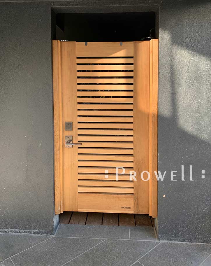 Site photograph showing horizontal wood fence gate #62 in a stucco entry.