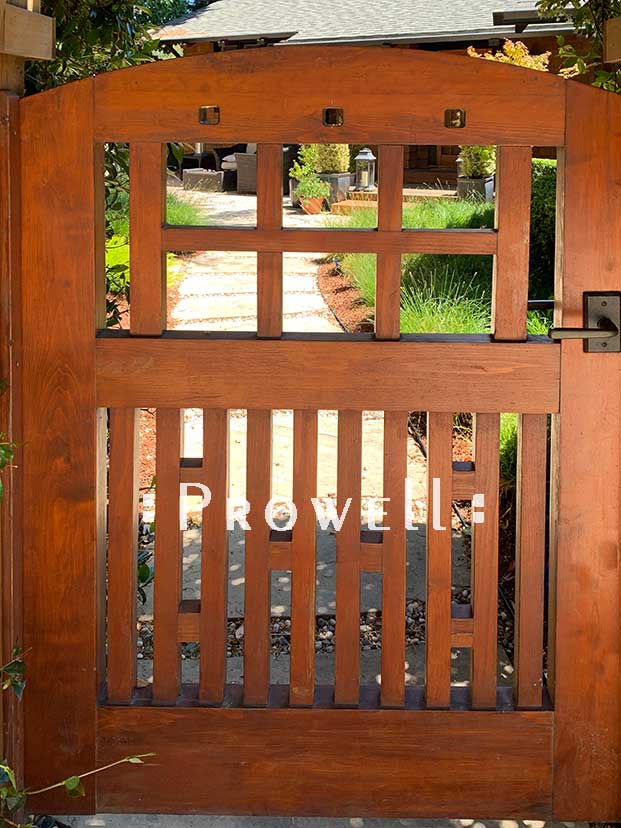 site photo showing curved wooden gates #53-6 13 years after installation